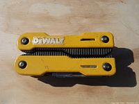 Closed view of yellow Dewalt multi-tool showing logo and casing.