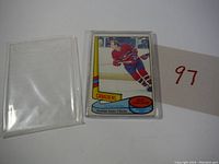Photo of 1980-81 Guy Lafleur hockey card in plastic protective case, showing front with player in Montreal Canadiens uniform and All-Star designation.