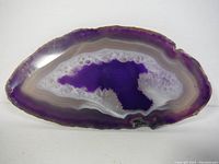 Front view of the first polished amethyst geode slice showing rich purple center and white crystalline bands