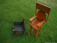 Top view of the oak high chair and the small rocking chair on grass.