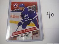 Front view of the Auston Matthews rookie year hockey card showing the player in action in Toronto Maple Leafs blue uniform with the text 'Canada's Rookies' and card branding by Upper Deck.