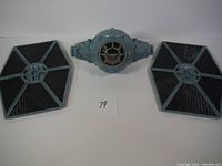 Photo shows the main cockpit body and two detached hexagonal wings of the TIE Fighter toy.