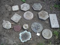 Full view of 15 assorted stepping stones laid on ground showing various shapes and textures