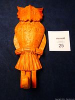 Front view of owl coat hook, wings closed, showing detailed carving and natural wood finish.