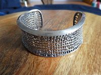 Close-up image of sterling silver mesh cuff bracelet showing detailed mesh design and slight patina.