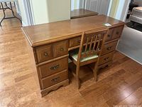 Full view of maple double pedestal desk with visible wear and 7 drawers