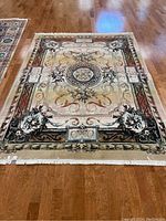 Front view of Persian area rug showing central medallion and floral patterns in brown and beige tones with fringe edges.