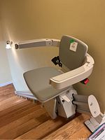 Elan straight stairlift installed on staircase showing seat, armrests, footrest and rail