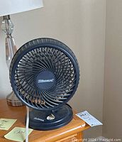 Black Blizzard table fan with circular grill and Holmes logo on base