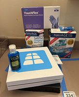 TouchFlex nitrile gloves box, Naväge nasal irrigation device, SaltPod refills, Tens X TENS gel bottle, and unopened FlexAbs kit box.