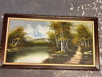 Full view of the framed landscape painting showing the mountain, lake, and trees.