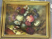 Framed full view of the antique signed floral still life painting showing bouquet in green vase and seashell.