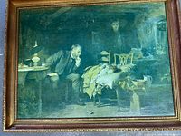 Full view of the vintage framed oil painting showing a man in a suit sitting beside a bed with a child lying on it, set in a dark interior scene.