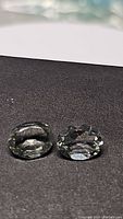 Two oval cut green amethyst (prasiolite) gemstones viewed from top showing color and clarity.