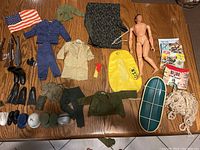 Full layout of G.I. Joe figure, clothing, accessories, weapons, flags, and gear on wooden surface