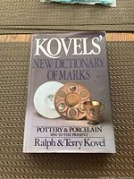 Photo of the book cover showing the title Kovels' New Dictionary of Marks and images of pottery items