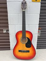 Full front view of the Nova acoustic guitar showing the body with sunburst finish and black pickguard.