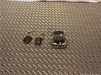 Photo showing a smokey quartz pendant and a pair of matching earrings on a woven textured surface.