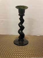 Full view of spinach jade spiral candle stick with dark green color and distinctive twisted stem, round base, and lighter green top rim.