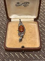 Brooch displayed in original vintage box showing Reeves Jewelry Store Barrie Ontario branding and brooch details.