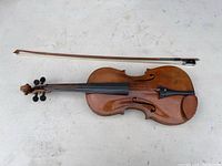 Full view of violin and bow showing overall shape and finish