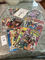 Wide view of all 20 Marvel comic books laid out, visible titles include X-Men, Captain America, TekWorld, and Marvel Super Heroes Summer Special with multiple colorful covers.