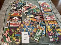 Comic bundle laid out on the floor showing various Marvel comic book titles.
