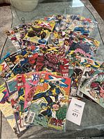 Full display of 30 Marvel comic books spread out on a table.