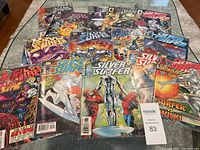 Overview of the 14 Silver Surfer comic books spread on a surface showing their covers