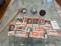 Photo showing three collectible baseballs and multiple San Francisco Giants 2014 postseason game tickets spread on glass table.