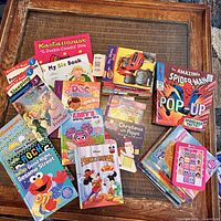 Photo showing over 20 children's early reader books featuring Disney, Sesame Street, Peppa Pig, Spider-Man and other popular characters