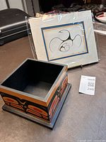 Jackson Beardy print on board in protective wrapping along with square bentwood box with Indigenous art designs on all sides; box interior plain black