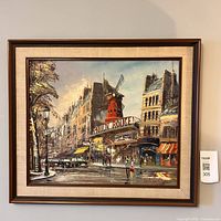 Frontal photo of the full framed oil painting showing the Moulin Rouge and adjacent Paris buildings street scene.