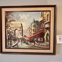 Full view of framed oil painting depicting Paris street scene with Arc de Triomphe, pedestrians and a café.