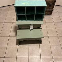 Top view of painted wood cubby and stool showing overall condition and paint wear