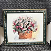 Full view of the framed watercolour print showing a terra cotta pot with red, pink, and white flowers and detailed leaves.