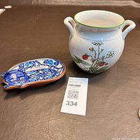 Blue and white cat-shaped trinket dish with intricate patterns, made of signed red clay.