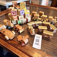 Full view of wooden train set and stacked building blocks on the table.