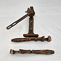 Photo showing Ford Model T car jack and two monkey wrenches laid flat for size and detail view