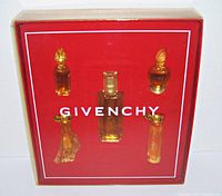 View of the Givenchy perfume set in original red box with plastic cover showing 5 distinct miniature bottles