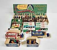 Overall lot showing multiple boxes of vintage Christmas light bulbs and string lights arranged facing front with colorful bulbs visible.