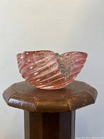 Side view of square-shaped pink gold aventurine Italian Murano glass bowl with leaf detail.