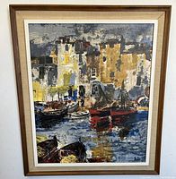 Frontal view of the oil painting on canvas depicting a Mediterranean harbor scene, showing boats and buildings with reflections in water, in a wooden mid-century modern frame.