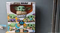 Front view of unopened Star Wars Mandalorian Grogu Galactic Snacking Toy showing the front of the box with colorful graphics and slight wear on the box edges.