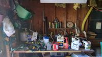 Overview of the garden workbench showing seed spreader, sprayers, and various chemicals.