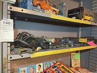 Shelf view showing transformer, track feeder connectors, locomotive chassis and mixed rolling stock