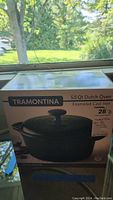 Full view of sealed box showing the Tramontina branding and 5.5 quart Dutch oven image with green color and black knob.