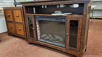 Front view of dark brown wood console with electric fireplace insert flanked by two cabinets