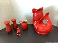 Group photo showing the fish pitcher, salt and pepper shakers, creamer, and rooster figurine together on a white background.