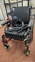 Front angle view of Solara wheelchair showing air cushion seat, armrests, caster wheels, and footrests.